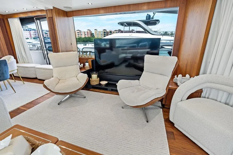 Sea Zar Yacht Photos Pics Luxurious interior of 2019 Sunseeker 86 Yacht with modern seating and large TV.