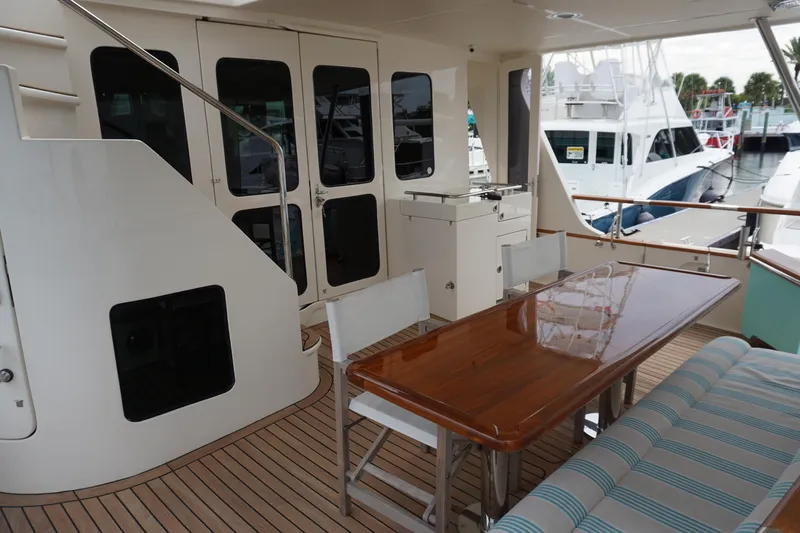 Novia II Yacht Photos Pics 2020 Marlow 66E yacht deck with dining table and seating area.