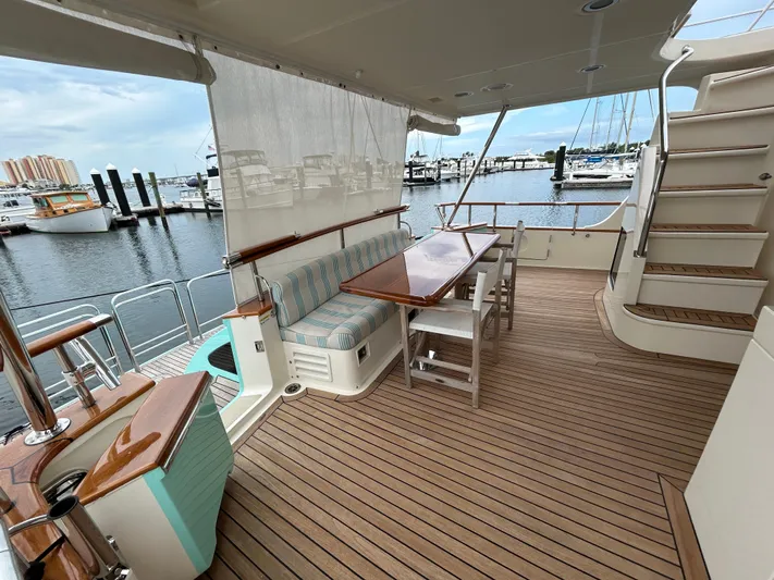 Novia II Yacht Photos Pics Outdoor deck of 2020 Marlow 66E yacht with seating and dining area.