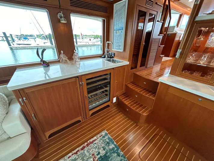 Novia II Yacht Photos Pics Luxurious 2020 Marlow 66E yacht interior with wooden cabinetry and waterfront view.