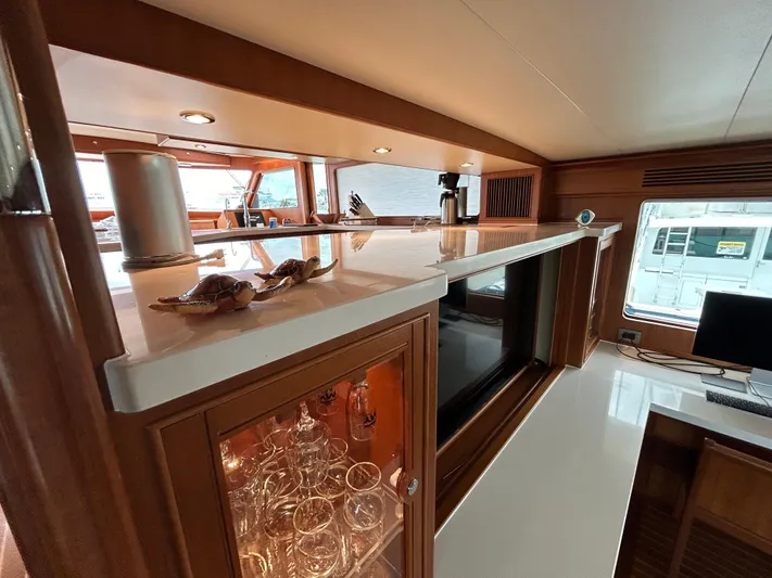 Novia II Yacht Photos Pics Luxurious interior of 2020 Marlow 66E yacht with elegant wood and glass accents.