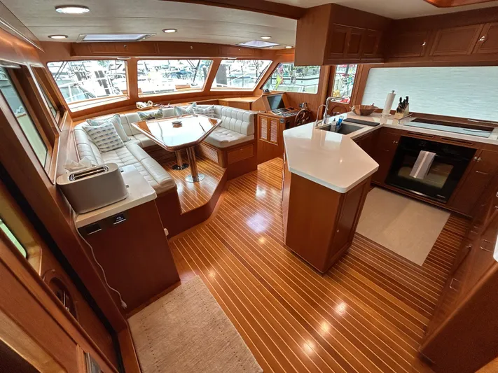 Novia II Yacht Photos Pics Luxurious interior of 2020 Marlow 66E yacht with modern kitchen and seating area.