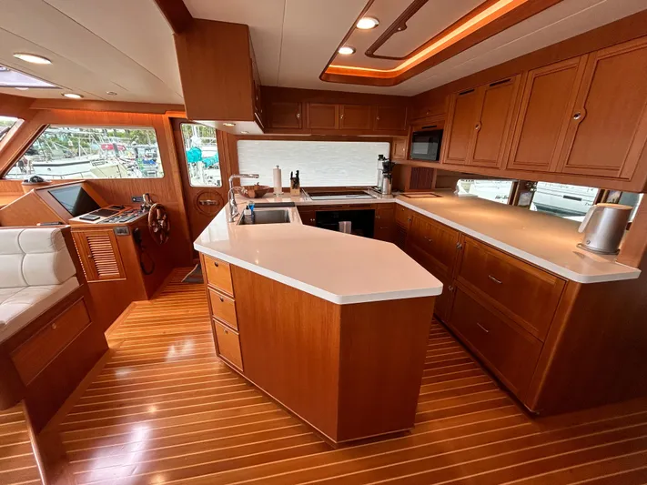 Novia II Yacht Photos Pics Luxurious Marlow 66E 2020 yacht interior with modern kitchen and wooden flooring.