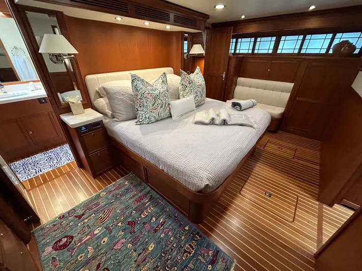 Novia II Yacht Photos Pics Luxurious Marlow 66E 2020 yacht bedroom with elegant wood finish and cozy bedding.