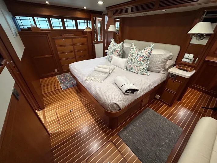 Novia II Yacht Photos Pics Luxurious Marlow 66E 2020 yacht bedroom with elegant wood finish and cozy bedding.