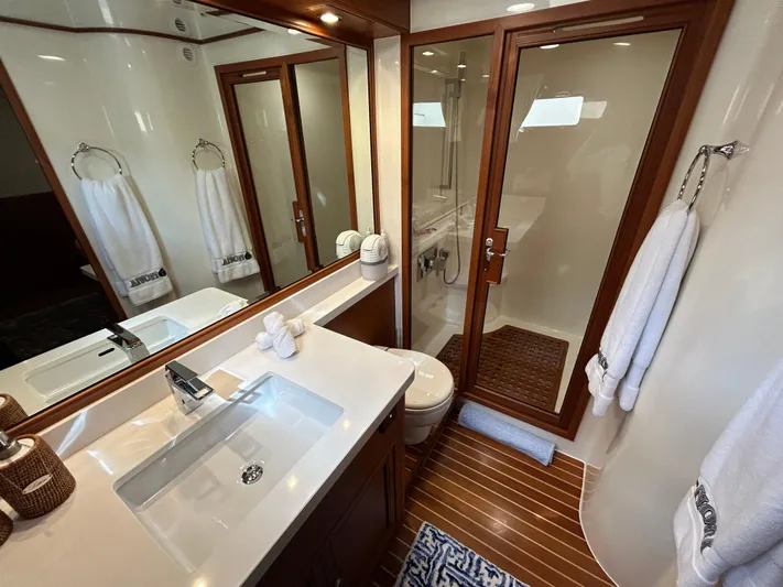 Novia II Yacht Photos Pics Luxurious bathroom in 2020 Marlow 66E yacht with wood accents and modern fixtures.