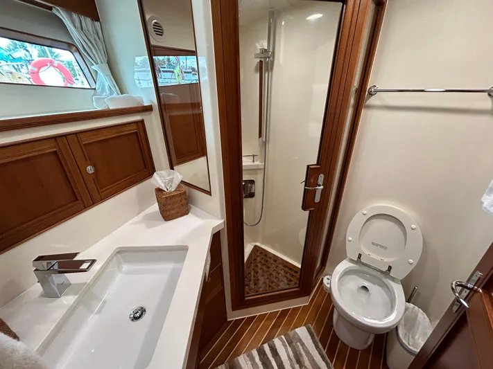 Novia II Yacht Photos Pics Luxurious Marlow 66E 2020 yacht bathroom with modern fixtures and wooden accents.