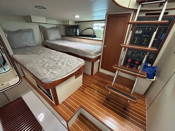 Novia II Yacht Photos Pics Cabin interior of 2020 Marlow 66E yacht with twin beds and wooden flooring.