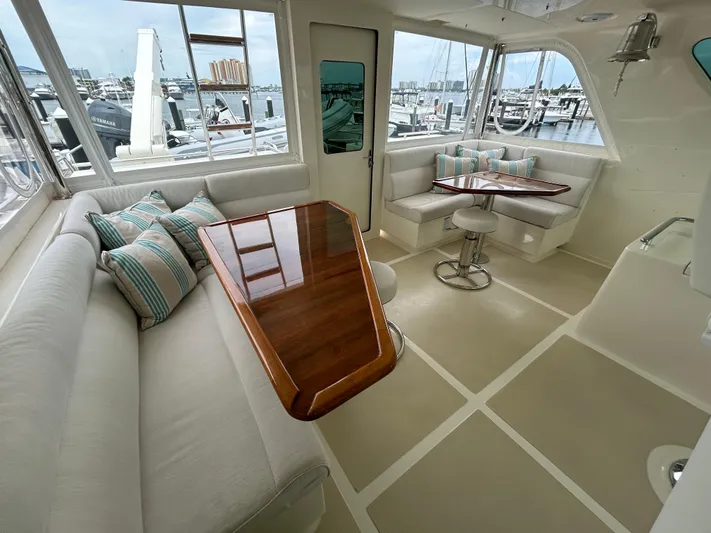 Novia II Yacht Photos Pics Luxurious 2020 Marlow 66E yacht interior with elegant seating and polished wood table.
