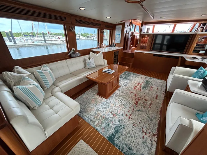 Novia II Yacht Photos Pics Luxurious interior of 2020 Marlow 66E yacht with elegant seating and large windows.