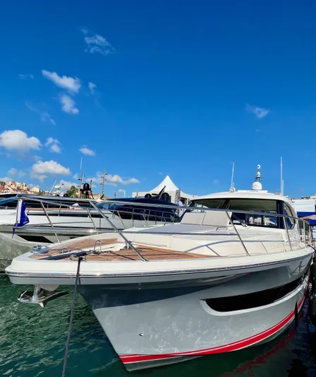 Scorpius Yacht Photos Pics 2022 Riviera 505 SUV yacht docked under clear blue sky.