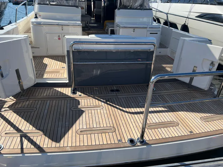 Scorpius Yacht Photos Pics 2022 Riviera 505 SUV yacht deck with sleek wooden finish and modern design.