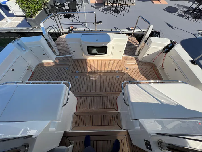 Scorpius Yacht Photos Pics 2022 Riviera 505 SUV yacht deck with teak flooring and modern design.