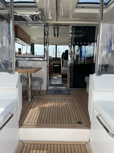 Scorpius Yacht Photos Pics Interior view of 2022 Riviera 505 SUV luxury yacht with modern design and wooden flooring.