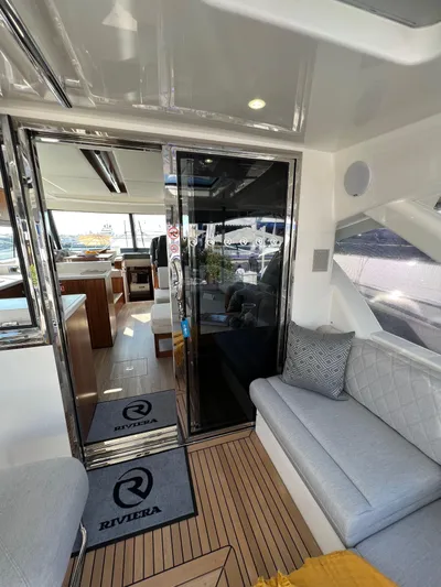 Scorpius Yacht Photos Pics 2022 Riviera 505 SUV interior with modern seating and sleek design.