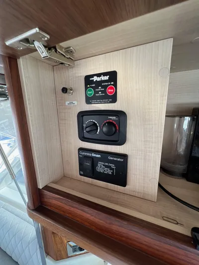 Scorpius Yacht Photos Pics Control panel inside 2022 Riviera 505 SUV yacht, featuring Parker and Cummins Onan generator controls.