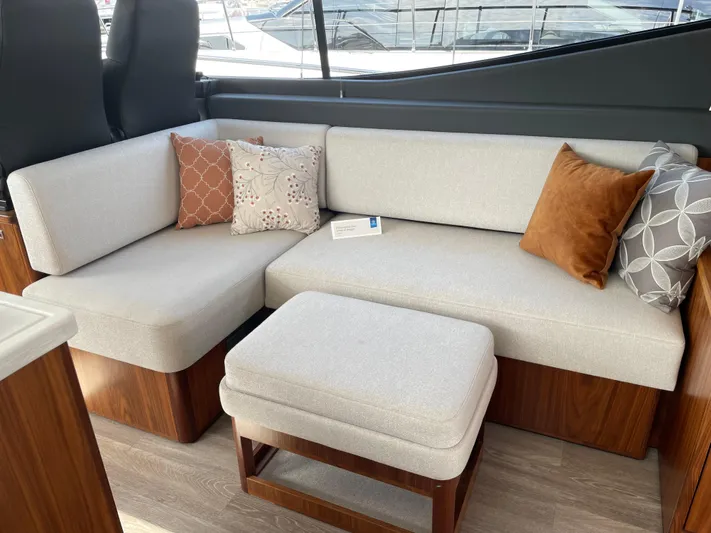 Scorpius Yacht Photos Pics Luxurious 2022 Riviera 505 SUV interior with elegant seating and stylish cushions.