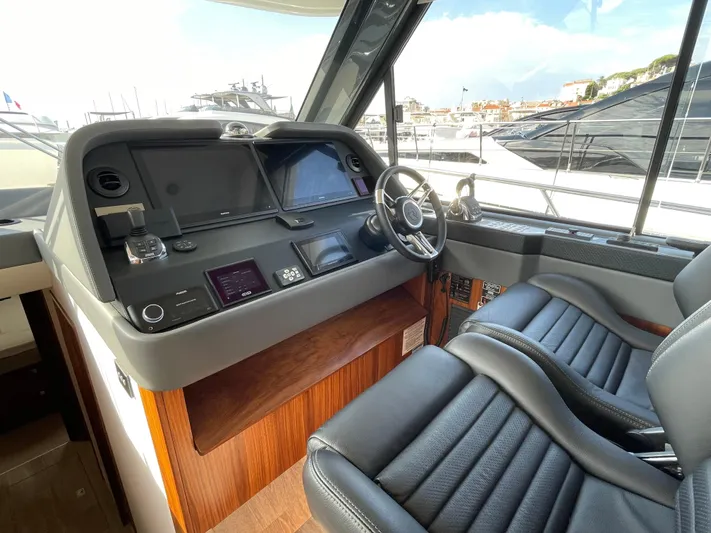 Scorpius Yacht Photos Pics 2022 Riviera 505 SUV helm with modern controls and luxurious seating.