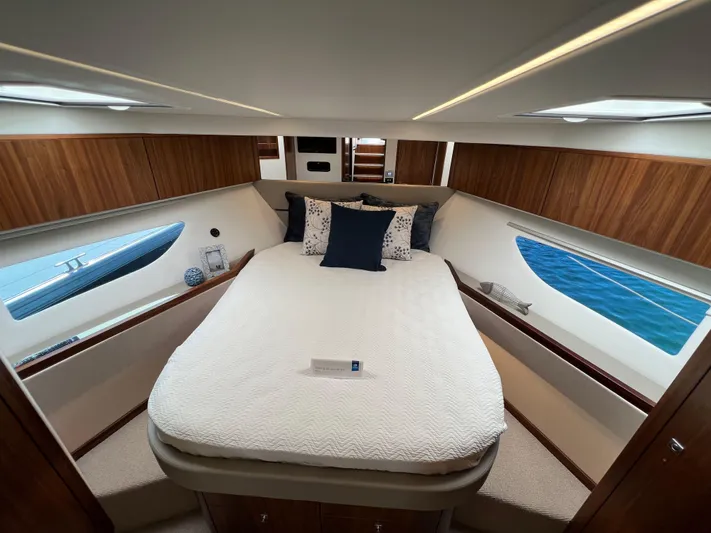 Scorpius Yacht Photos Pics Luxurious bedroom interior of 2022 Riviera 505 SUV yacht with ocean view.