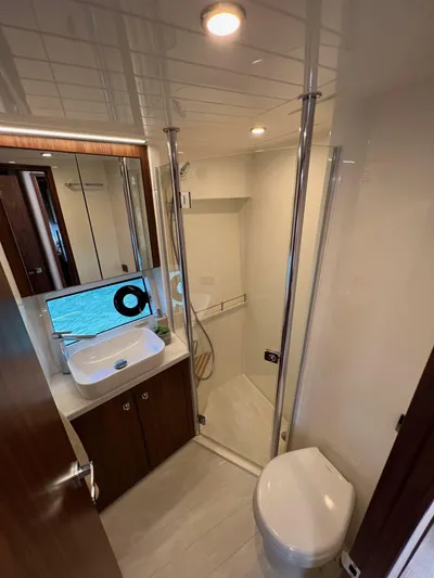 Scorpius Yacht Photos Pics Luxurious bathroom in 2022 Riviera 505 SUV yacht with modern fixtures and elegant design.