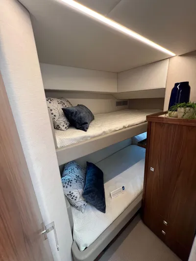 Scorpius Yacht Photos Pics 2022 Riviera 505 SUV interior with cozy bunk beds and modern design.