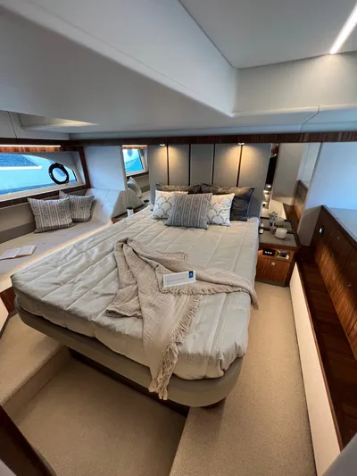 Scorpius Yacht Photos Pics Luxurious bedroom interior of 2022 Riviera 505 SUV yacht with elegant bedding and modern design.