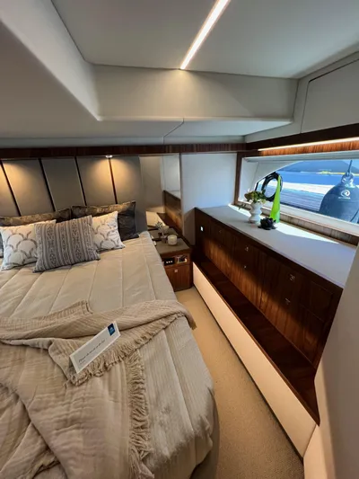 Scorpius Yacht Photos Pics Luxurious bedroom interior of 2022 Riviera 505 SUV yacht with elegant decor and ocean view.