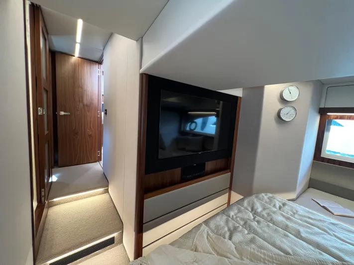 Scorpius Yacht Photos Pics Luxurious interior of 2022 Riviera 505 SUV yacht with modern bedroom and TV.