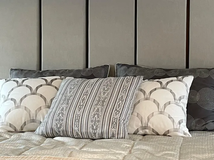 Scorpius Yacht Photos Pics Luxurious bed with patterned pillows in a 2022 Riviera 505 SUV.