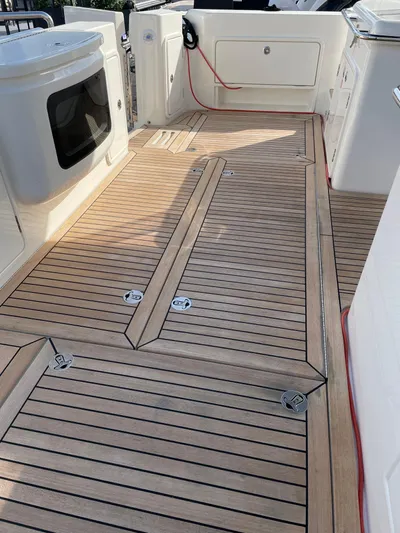 Scorpius Yacht Photos Pics Teak deck of 2022 Riviera 505 SUV yacht, featuring sleek design and modern amenities.