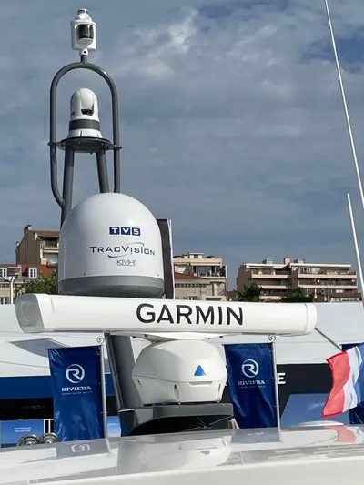 Scorpius Yacht Photos Pics Riviera 505 SUV 2022 yacht with Garmin and TracVision equipment, docked under a cloudy sky.