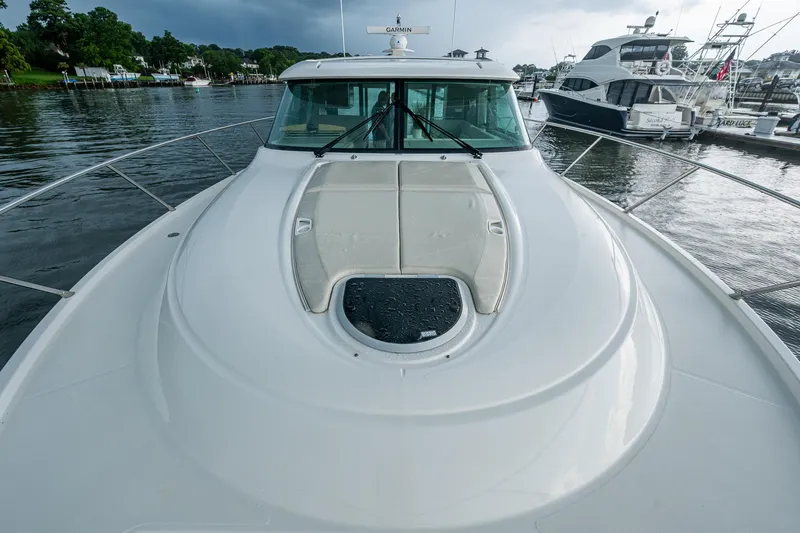  Yacht Photos Pics 2020 Tiara Yachts C44 Coupe on water, showcasing sleek deck design and marina backdrop.