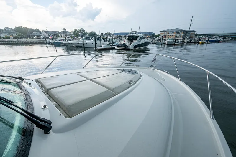  Yacht Photos Pics 2020 Tiara Yachts C44 Coupe docked in a marina, showcasing sleek design and luxury.
