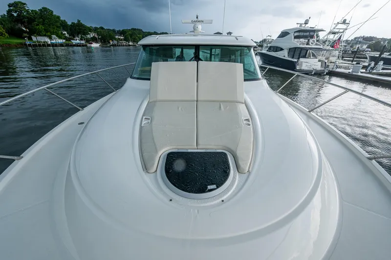  Yacht Photos Pics 2020 Tiara Yachts C44 Coupe on water, featuring sleek deck design and luxurious seating.