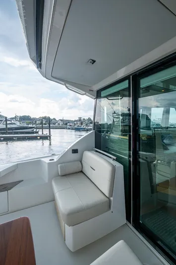  Yacht Photos Pics 2020 Tiara Yachts C44 Coupe, elegant seating area with marina view.