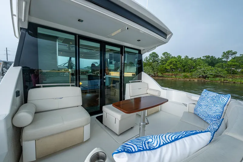  Yacht Photos Pics 2020 Tiara Yachts C44 Coupe, elegant outdoor seating with scenic water view.