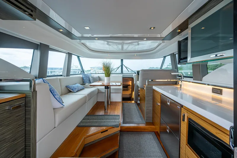  Yacht Photos Pics Luxurious interior of 2020 Tiara Yachts C44 Coupe with modern kitchen and seating area.