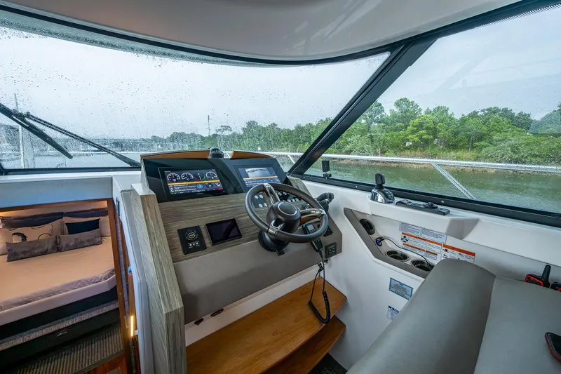  Yacht Photos Pics 2020 Tiara Yachts C44 Coupe helm with modern controls and cabin view.