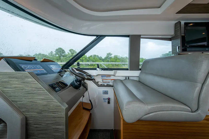  Yacht Photos Pics 2020 Tiara Yachts C44 Coupe helm with modern controls and comfortable seating.