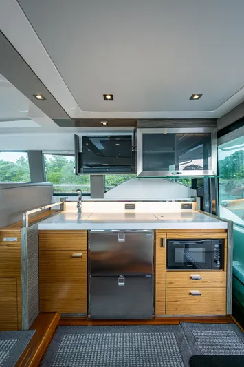  Yacht Photos Pics 2020 Tiara Yachts C44 Coupe interior kitchen with modern appliances and sleek design.