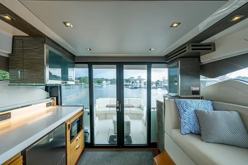  Yacht Photos Pics Interior of 2020 Tiara Yachts C44 Coupe, featuring modern kitchen and seating with waterfront view.