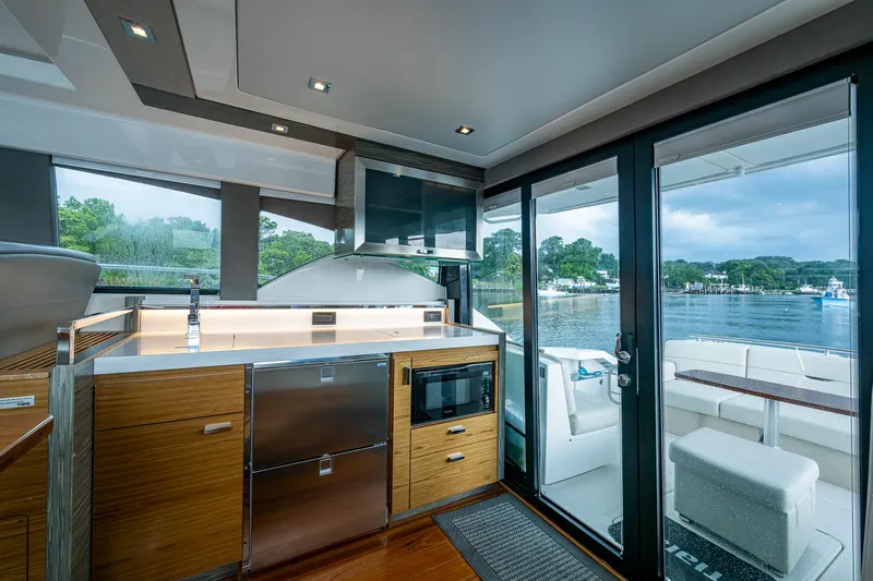 Yacht Photos Pics Modern interior of 2020 Tiara Yachts C44 Coupe with sleek kitchen and scenic water view.