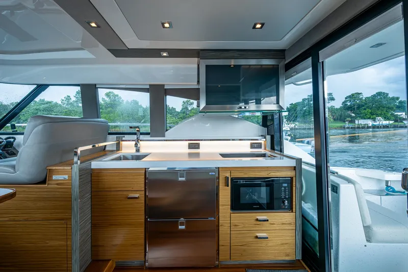  Yacht Photos Pics Luxurious 2020 Tiara Yachts C44 Coupe interior with modern kitchen and scenic water view.