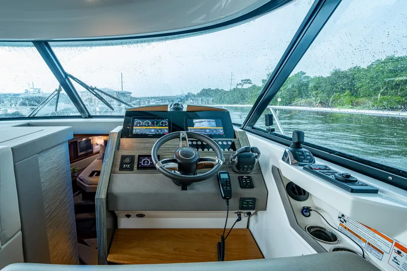  Yacht Photos Pics 2020 Tiara Yachts C44 Coupe helm with modern controls and scenic water view.