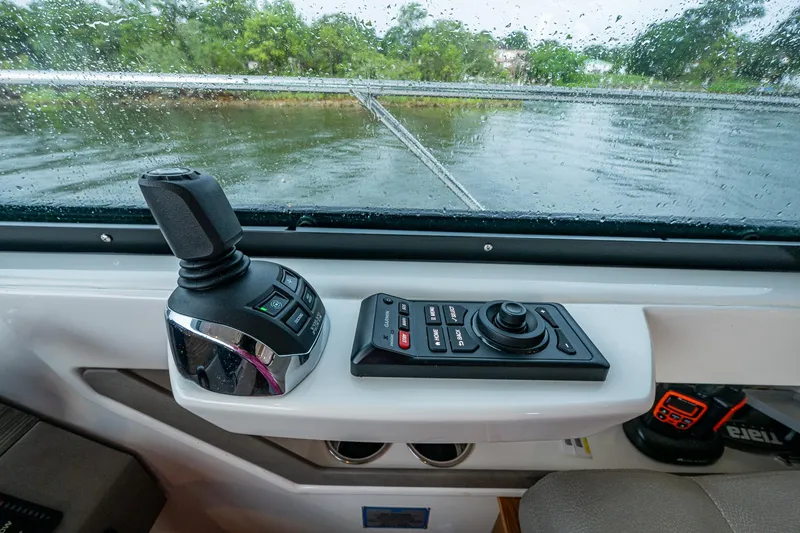  Yacht Photos Pics Control panel of 2020 Tiara Yachts C44 Coupe with joystick and buttons, rainy window view.