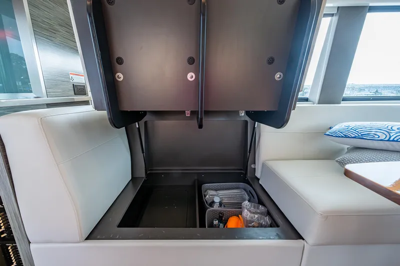  Yacht Photos Pics 2020 Tiara Yachts C44 Coupe interior storage compartment with organized items.