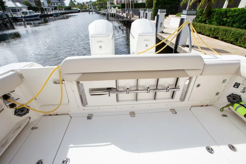 Double Nickel Yacht Photos Pics 2023 Boston Whaler 380 Outrage boat deck with dual engines, docked in a marina.