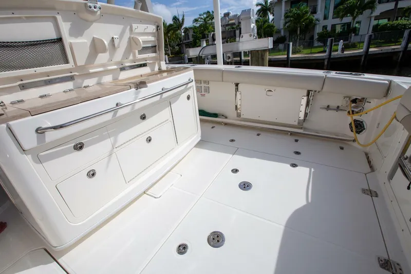 Double Nickel Yacht Photos Pics 2023 Boston Whaler 380 Outrage boat deck with storage compartments and seating.