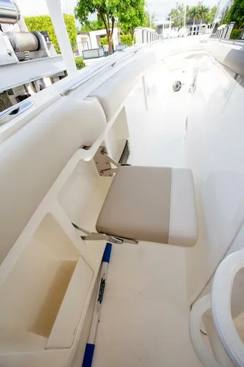 Double Nickel Yacht Photos Pics 2023 Boston Whaler 380 Outrage interior with foldable seat and sleek design.
