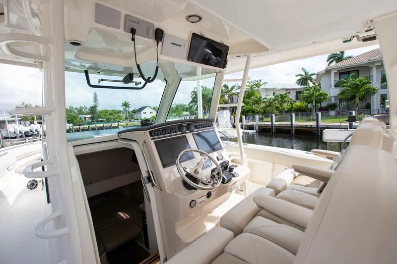 Double Nickel Yacht Photos Pics Interior view of 2023 Boston Whaler 380 Outrage boat, featuring modern helm and seating.